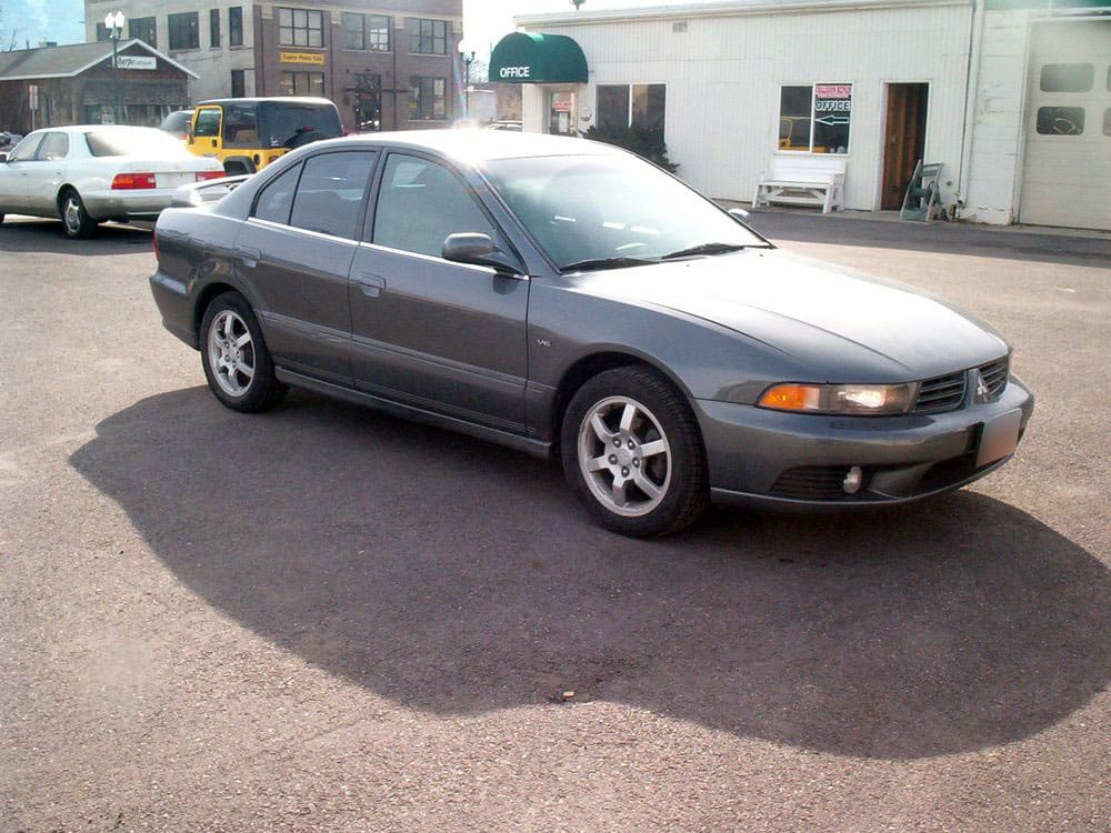 The same white car after dent and body repair, side view